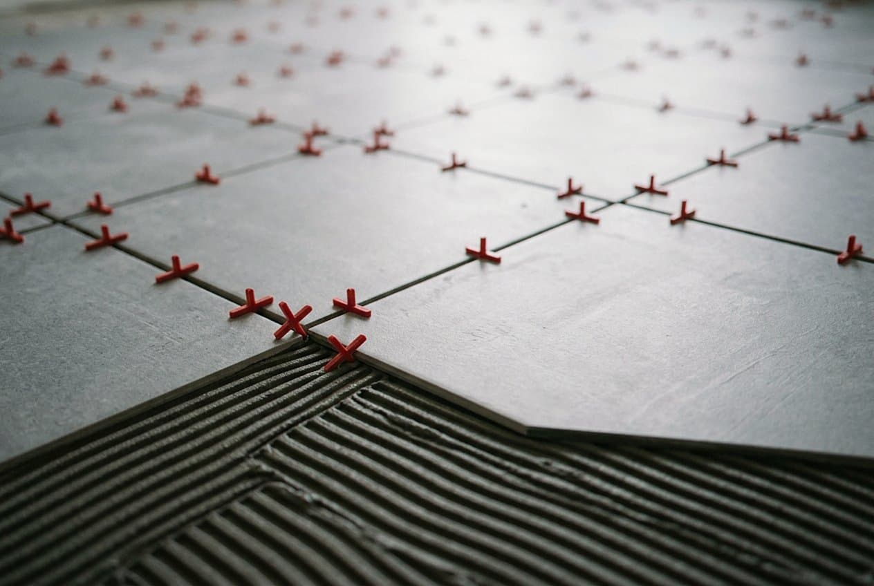 Red cross spacers on a large-format tile floor